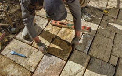 landscaper building a garden path with sandstone